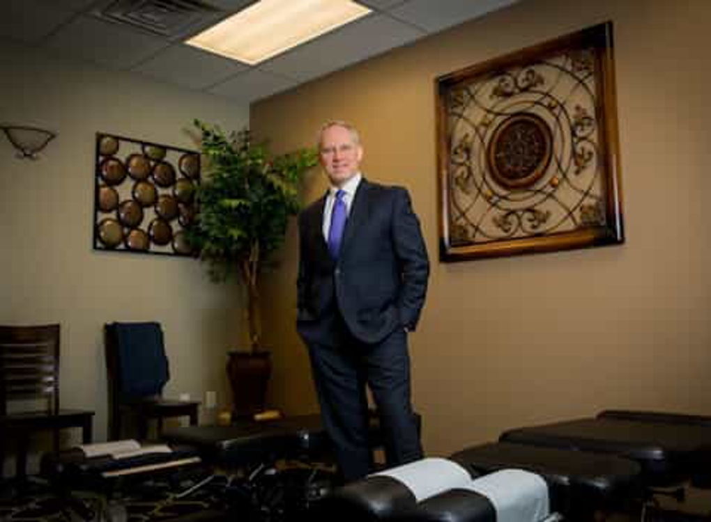 Man in suit and in his office