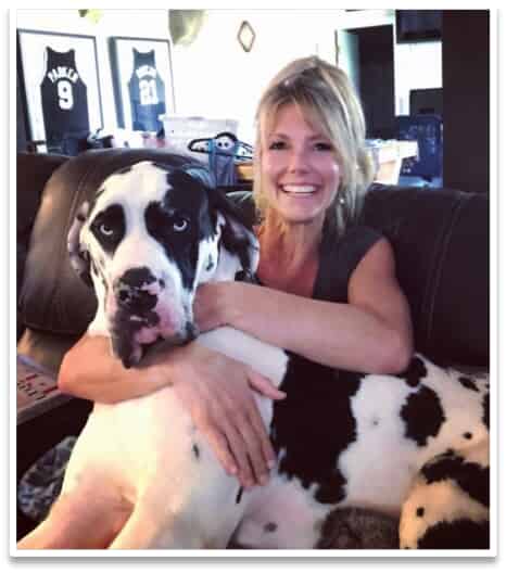 Woman with dog smiling at camera